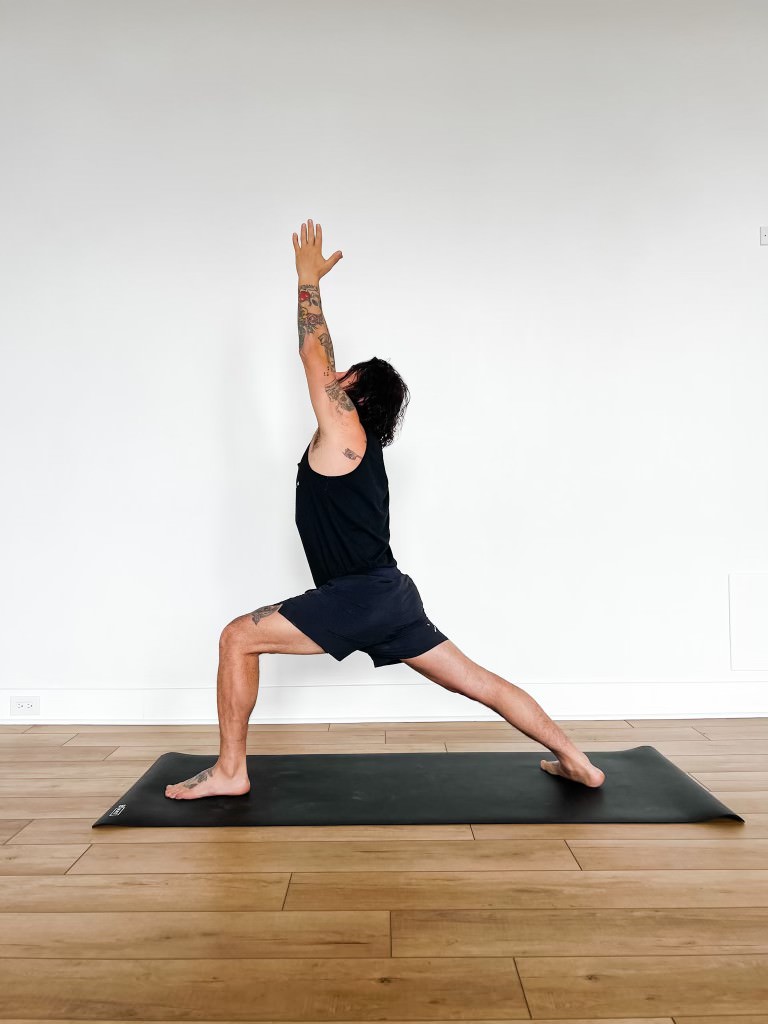 A Woman Practicing A Yoga Pose Standing On One Leg And Arms Lifted