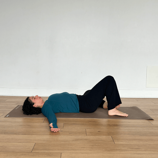 A person lying on their back, windshield wiping their knees