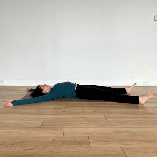 Person lying on the floor in a "Human X" shape (arms and legs spread out to create an x-shape, or star shape)