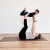 Kids yoga photo of Kate Lombardo with her toddler in flying airplane pose