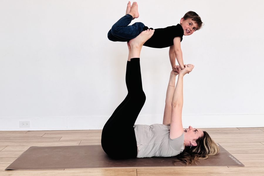 Kids yoga photo of Kate Lombardo with her toddler in flying airplane pose