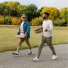 A photo of Patrick Franco and Jordan taking a mindful walk, carrying their rolled up yoga mats